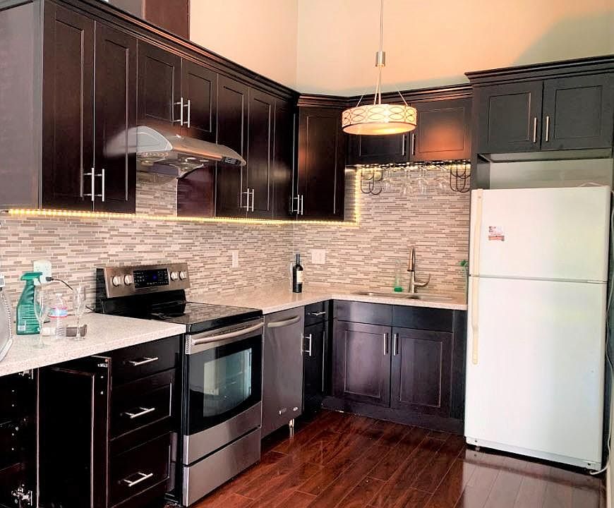 Kitchen: Granite countertop, wood cabinet and modern appliances.