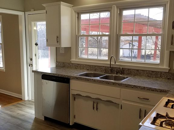 Kitchen with view to west and back yard with pergola.