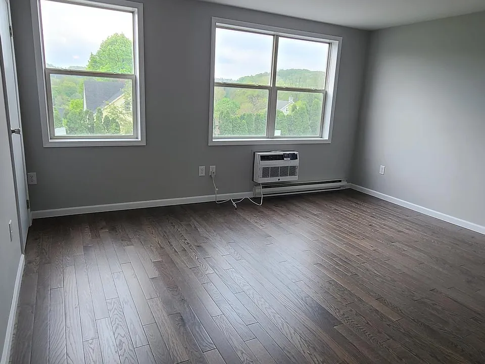View of spacious oversized living room, new hardwood floors throughout with new efficient smart air conditioners