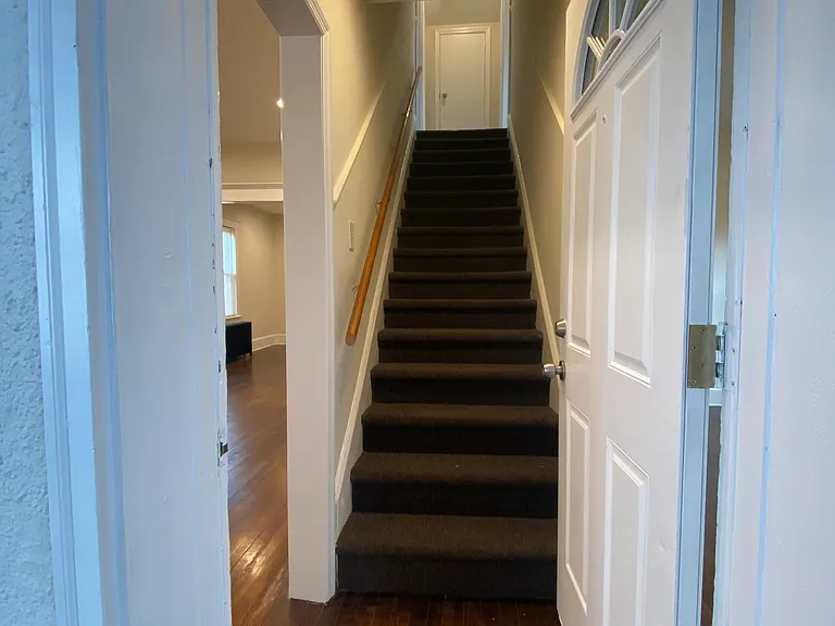 front entrance, stairs to top floor separating the 2 top bedrooms