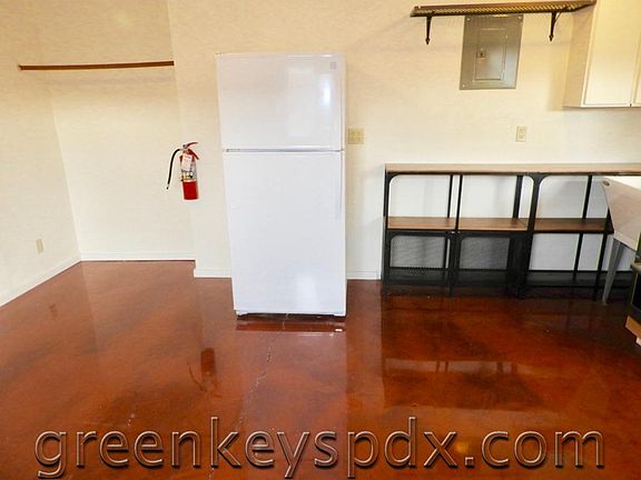 Refrigerator and an open closet to the left