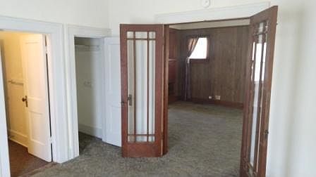 Front bedroom looking through French doors to the Living room. Bathroom to the left.