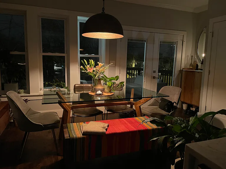 Dining area with entrance to back deck and parking.
