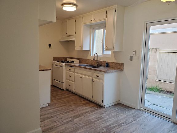 Recently painted kitchen with granite counters, stainless steel sink and upgraded gas cooking range - not shown