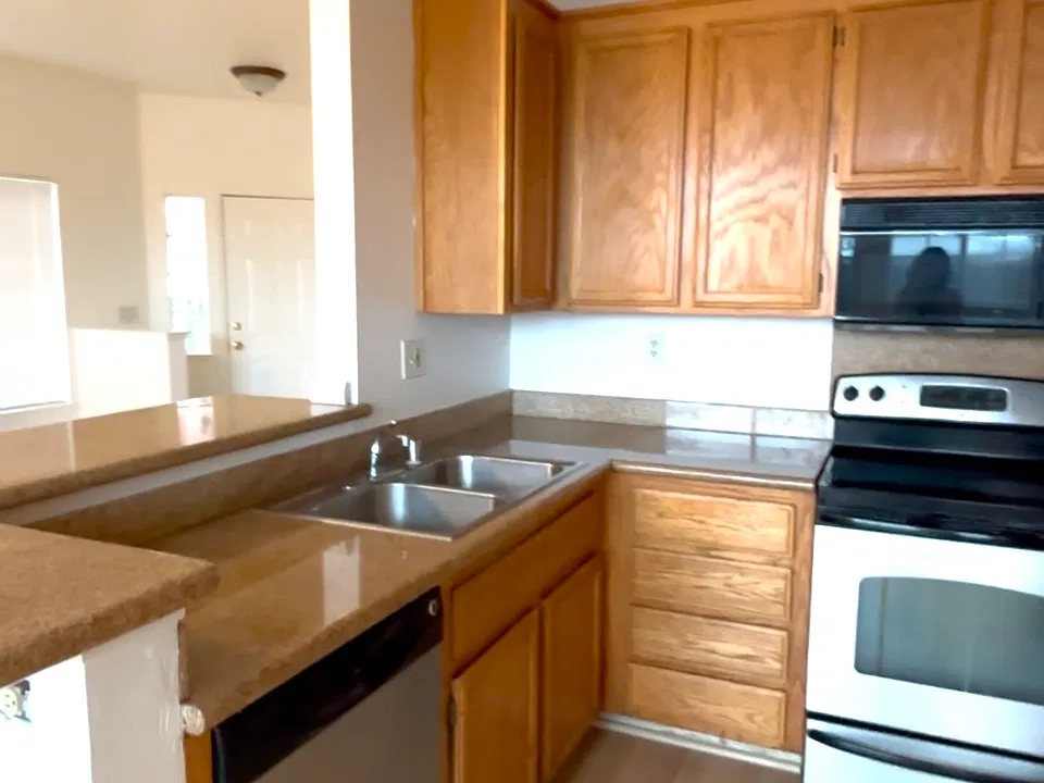 Kitchen view with front door in background.