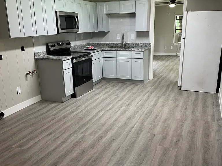 Kitchen with new appliances, includes washer dryer connections and space dining area