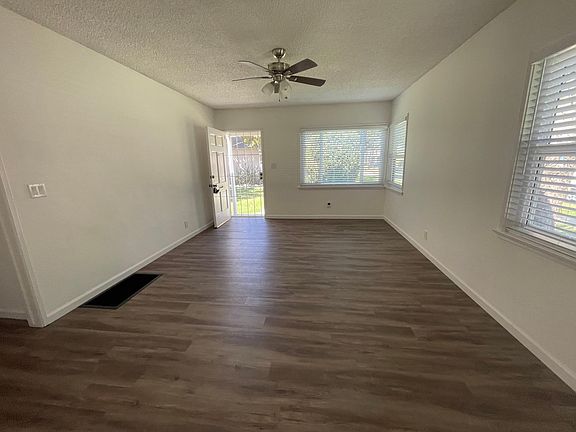 Spacious living room with new windows and flooring