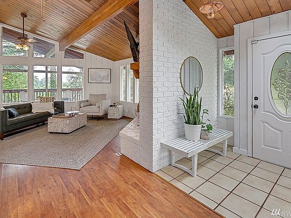 Spacious great room with vaulted wood ceiling, beams and tons of natural light!