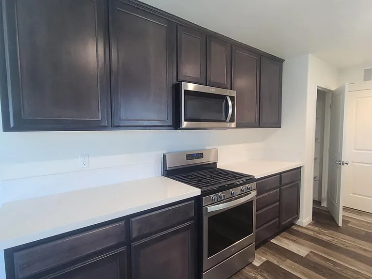 Kitchen. Door to Pantry. Ample counter space and cabinet storage.
