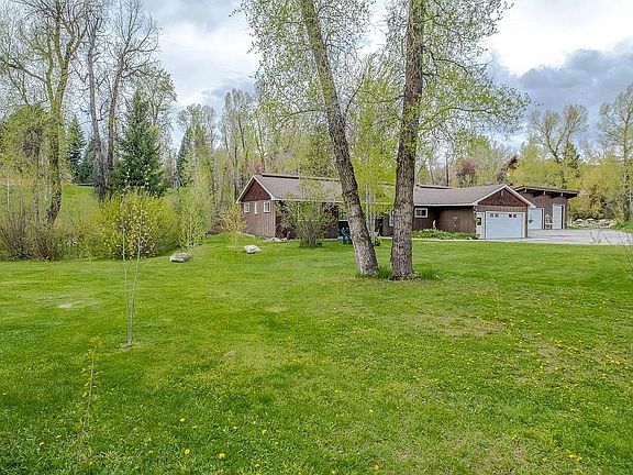Workshop/garage space can be seen to the right, detached from home.