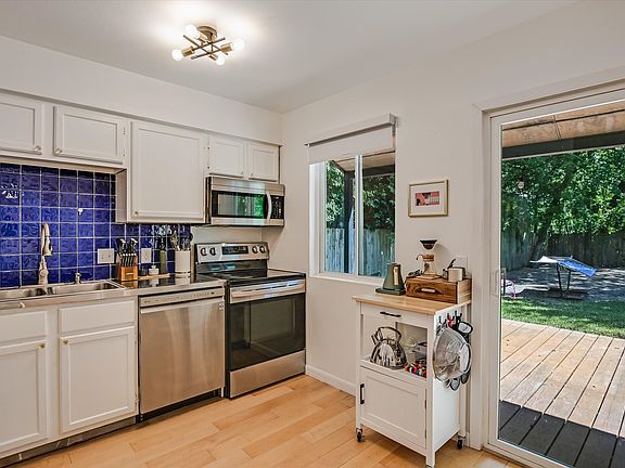 kitchen with sliding glass door leading to the large back yard and deck