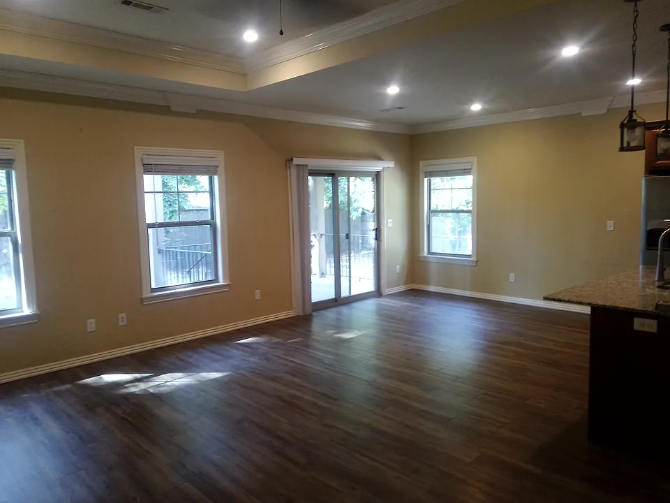 Large living room with an open floor plan. Recessed lighting with a fan. LVP floors.