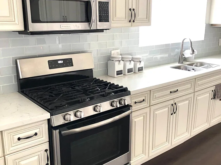 equipped with stainless steel appliances full stove, oven, microwave