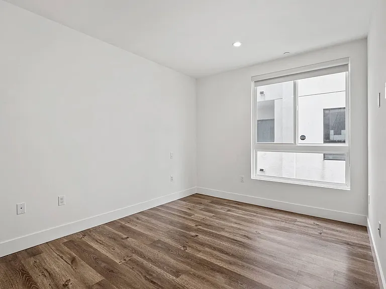 Bedroom with Large Windows, Recessed Lighting, and Vinyl Flooring