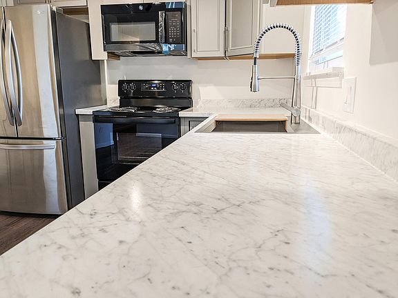 Updated counters, appliances, and sink in the kitchen