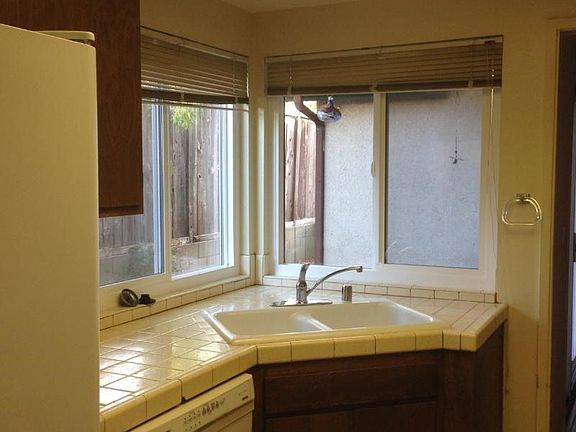 kitchen sink, view of side yard patio