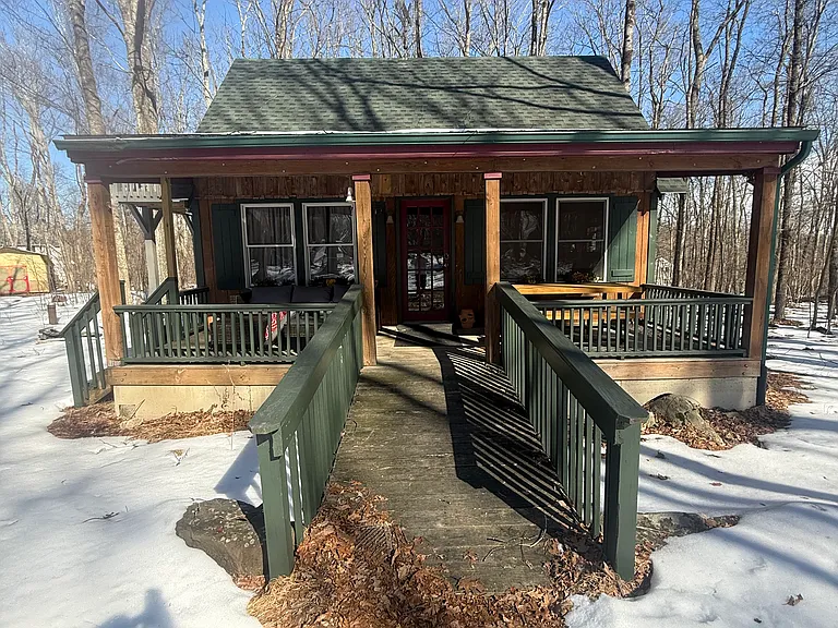 The home features a large front porch, accessible by ramp.
