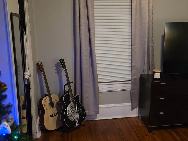 Bedroom One w/ Designer Ceiling Fan and Newly Refinished Hardwood Floors and Designer Paint.