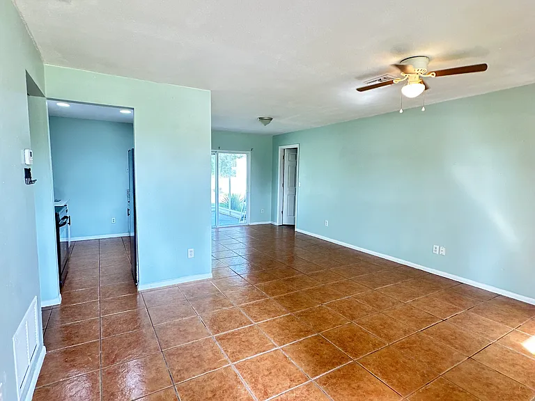 Living room with dining and kitchen area in view