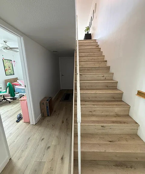 Stairs from Entry and bedrooms lower floor to upper level kitchen, LR, another Master BR