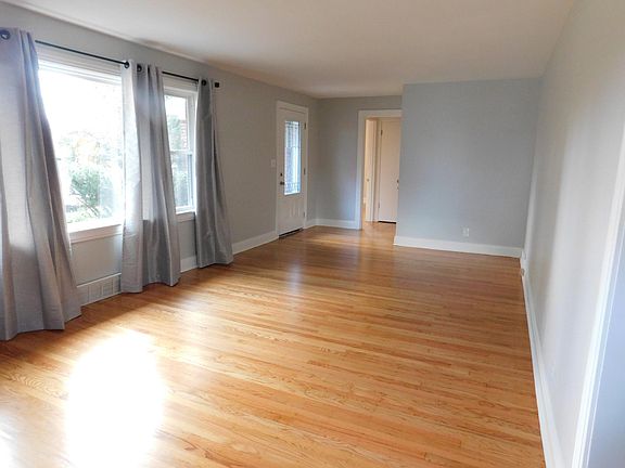 Living room with view of front door and hallway
