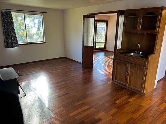 Side room on main floor, near kitchen and dining room. It has a wet bar and a wood burning stove. This is a great space for a family room or possible office area.