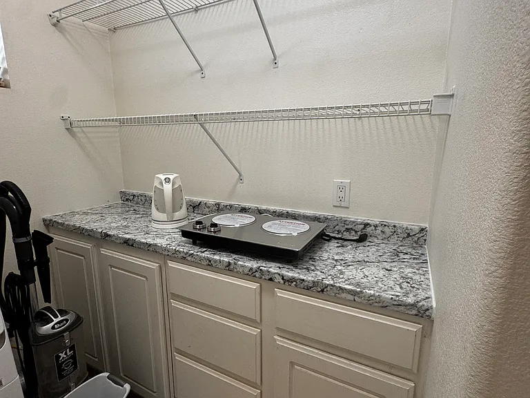 meal prep counter top, shelves to share, vacuum, washer/dryer, sink in Kitchenette/laundry room.