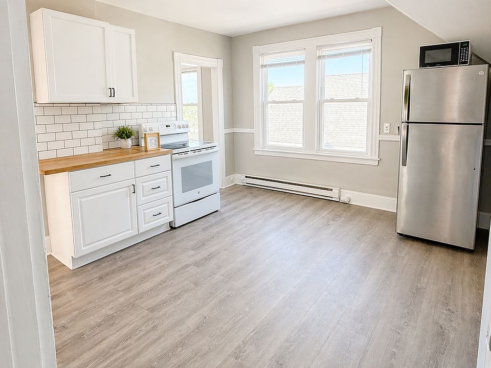Refreshed kitchen with new fixtures, cabinets, subway tile backsplash.