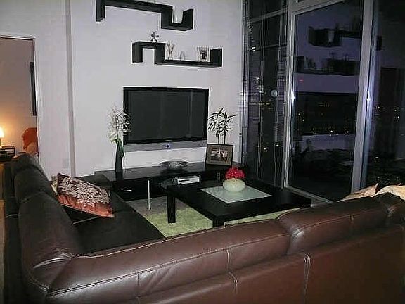 Living Area with floor to Ceiling Windows with Amazing Views of the City! 50' 