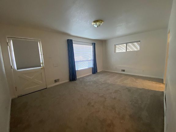 The living room has new carpeting, 2" blinds, newer curtains and newer thermal windows throughout the home.