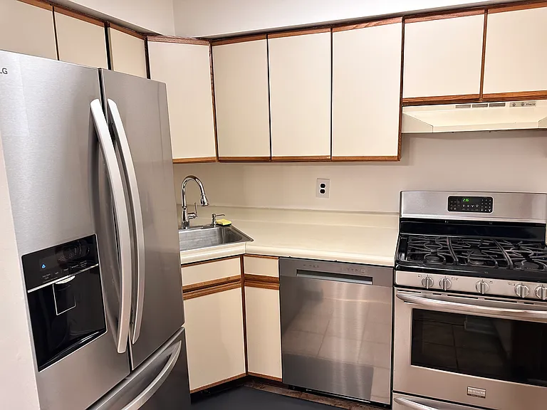 Kitchen with brand new refrigerator, dish washer, & gas stove.