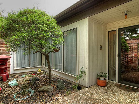 Enter through an iron gate into a private courtyard.