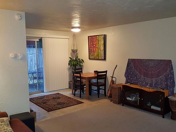 View from front door to Living/dining. Backyard is visible through sliding door. (Note: furnishings belong to a prior tenant; unit will be rented unfurnished)