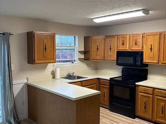 Kitchen, new floors, newer dishwasher, oversized refrigerator.