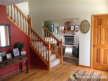 Inviting hardwood entryway with high ceilings