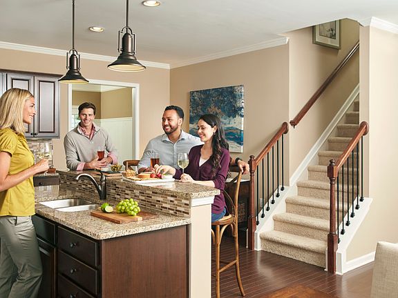 Friends gather together around the newly built kitchen island in the Sandhill