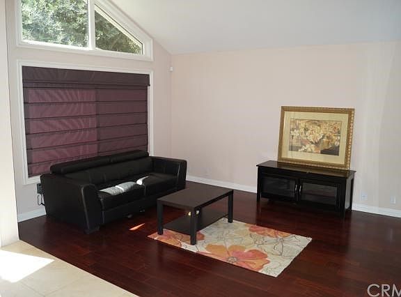 LIVING ROOM- high ceilings, scraped ceilings, large windows, quality Roman shades/curtains, wood floorings