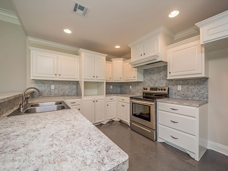 Open floor plan: kitchen area opens to the living room with snack bar behind the kitchen sink.
