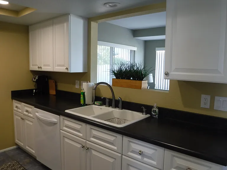 Kitchen has white cabinets