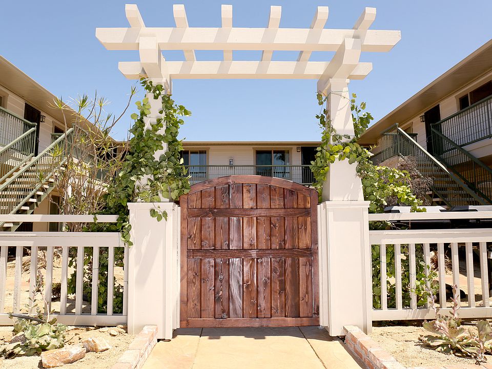 Wooden gate enterance to Harbor Villa Apartments in San Diego, California.