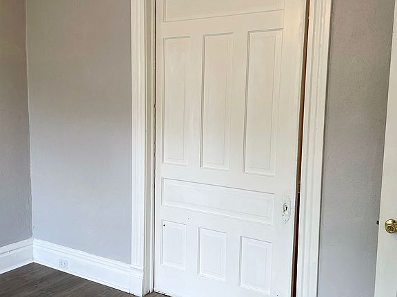 The pocket door partially closed, taken from the southern bedroom form the southeast corner