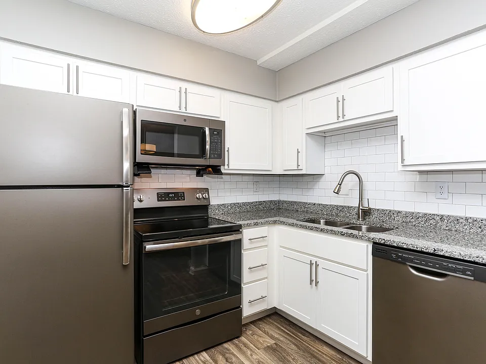 Kitchen with granite counters, stainless appliances & modern cabinetry