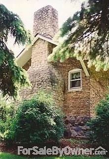 Street View of Living Room Fireplace
						:
						Massive stone chimney with copper flashing.