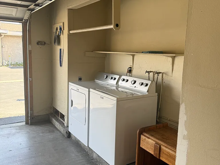 Two-car garage with washer/dryer and additional storage area. New wifi-enabled garage door opener.