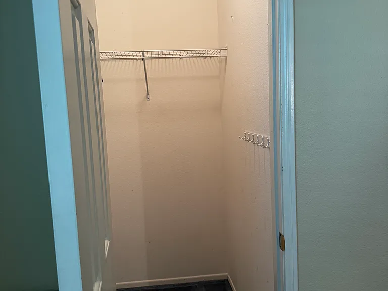 Bedroom#1: hooks & wrap-around shelf inside walk-in-closet