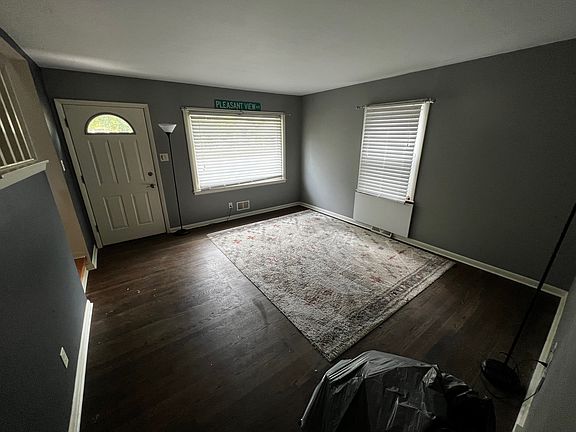 Bright living room with a large picture window overlooking the front yard