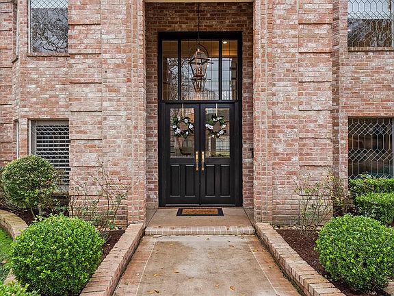 The custom-made front doors give the home a charming first impression.