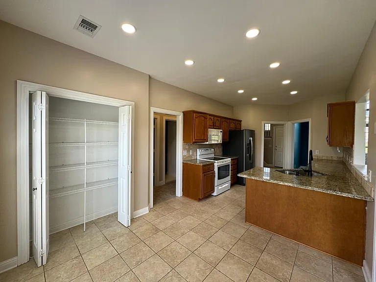 Kitchen View - Hallway leads to bedrooms 2 and 3 and second full bathroom
