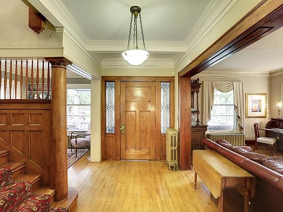 The entry foyer and transition space has a central focal point of a grand staircase but also provides a full and open view of the Parlor, the Living Room & Dining Room.  Gorgeous hardwood floors throughout with original woodwork.