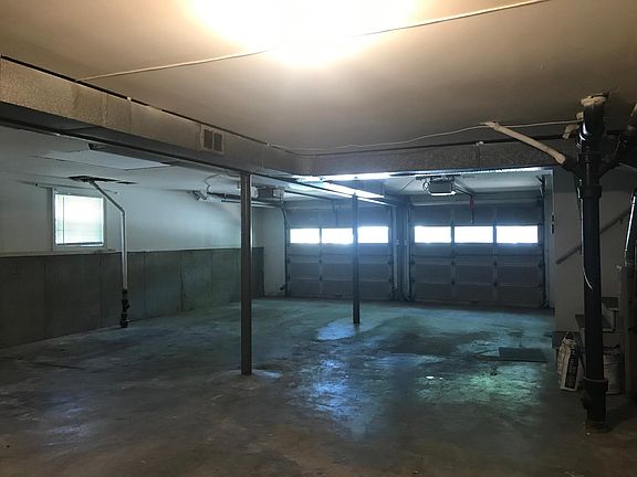 Oversized four car tandem garage is heated and cooled and provides a shared access to the entryway parlor. Your private lower-level is accessed through the garage.